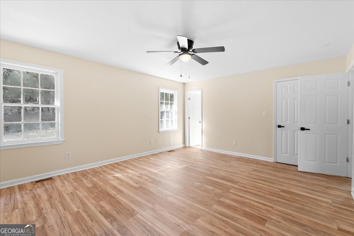 126 Waterfront Way Warner Robins, GA 31093 - Photo 24 of 60 a view of empty room with wooden floor and fan