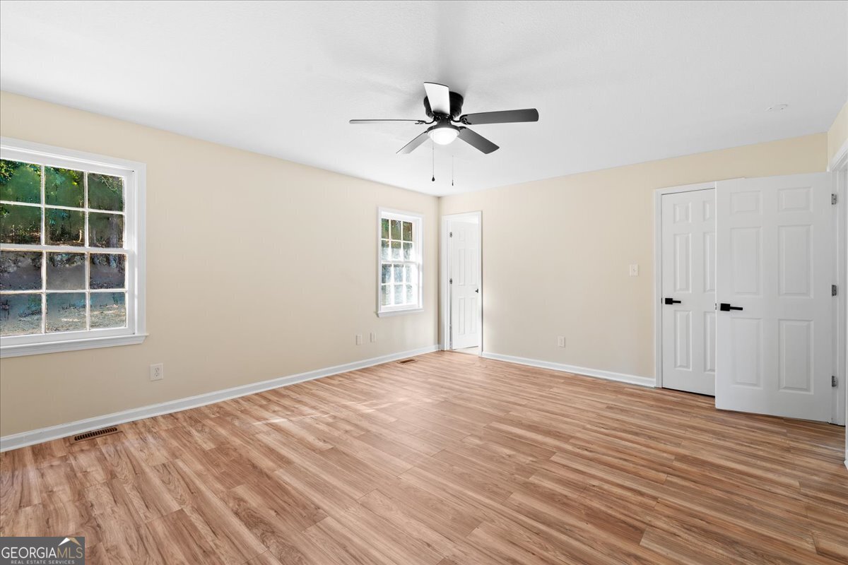 126 Waterfront Way Warner Robins, GA 31093 - Photo 25 of 60 a view of empty room with wooden floor and fan