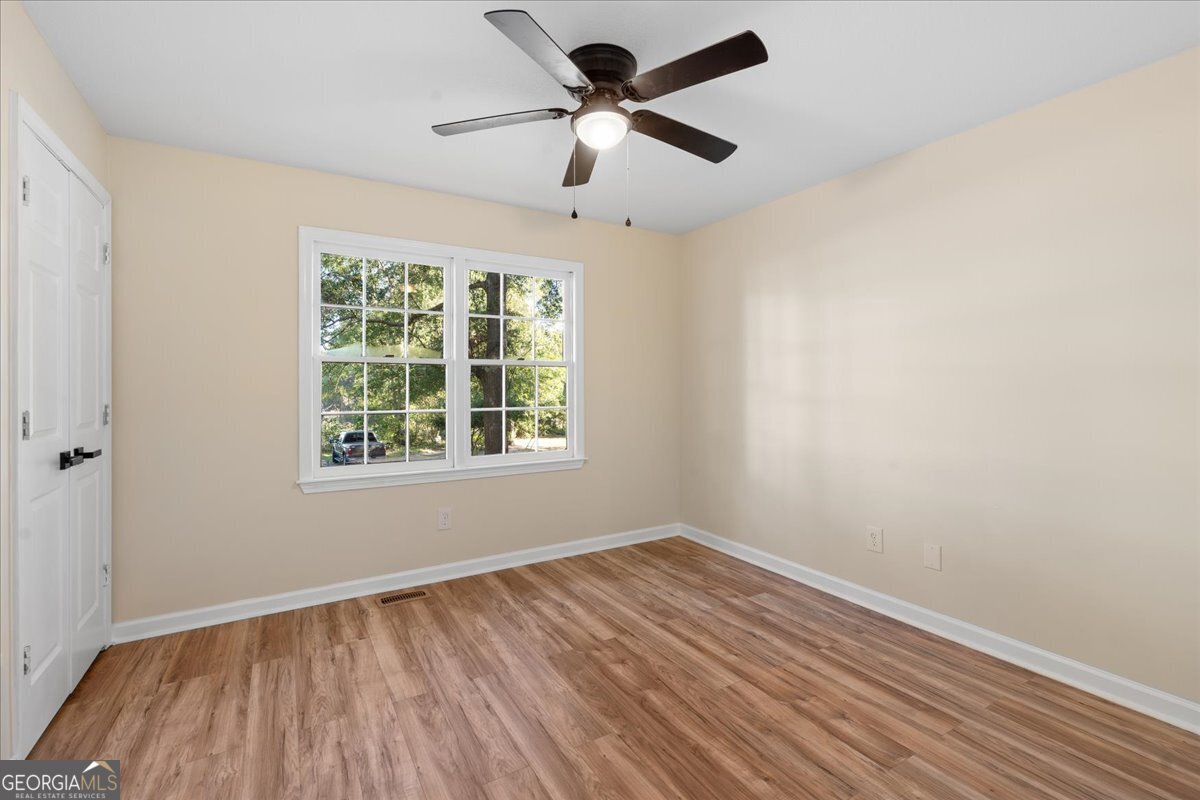 126 Waterfront Way Warner Robins, GA 31093 - Photo 27 of 60 wooden floor in an empty room with a window