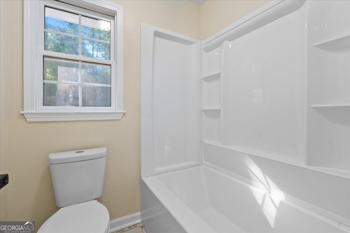 126 Waterfront Way Warner Robins, GA 31093 - Photo 30 of 60 a white toilet sitting next to a bath tub