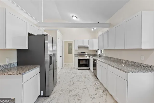 a view of a room with window a ceiling fan and wooden floor
