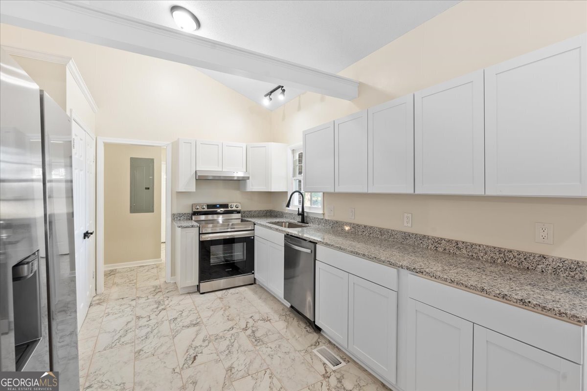 126 Waterfront Way Warner Robins, GA 31093 - Photo 36 of 60 a kitchen with stainless steel appliances granite countertop a stove and a sink