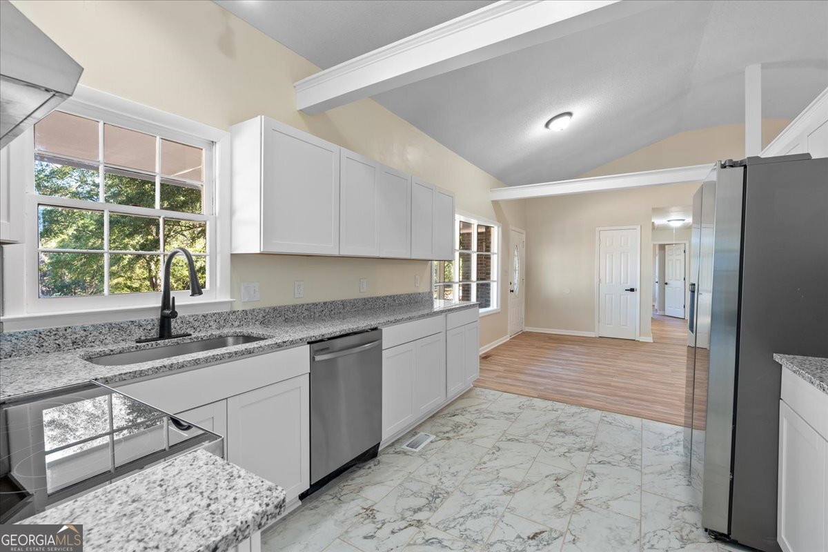 126 Waterfront Way Warner Robins, GA 31093 - Photo 39 of 60 a kitchen with stainless steel appliances granite countertop a refrigerator and a sink