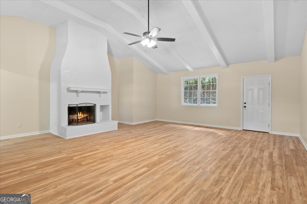 126 Waterfront Way Warner Robins, GA 31093 - Photo 43 of 60 a view of an empty room with wooden floor fireplace and a window