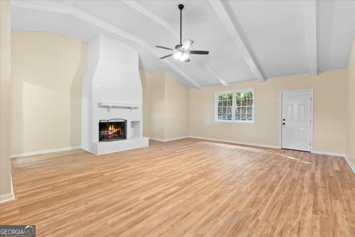 126 Waterfront Way Warner Robins, GA 31093 - Photo 44 of 60 a view of empty room with wooden floor and fireplace