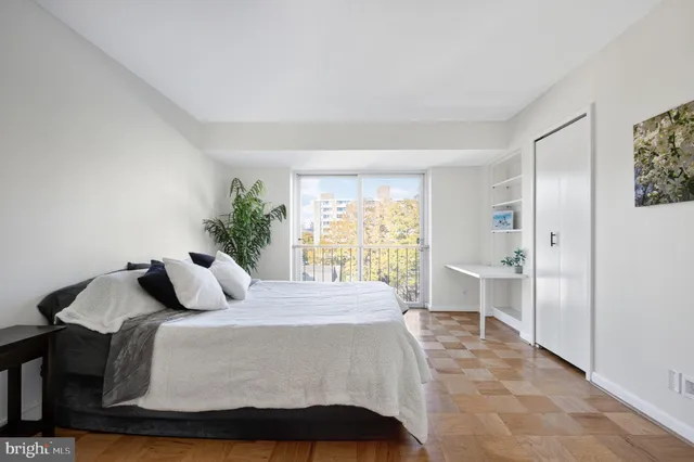 a bedroom with a bed and a table with closet