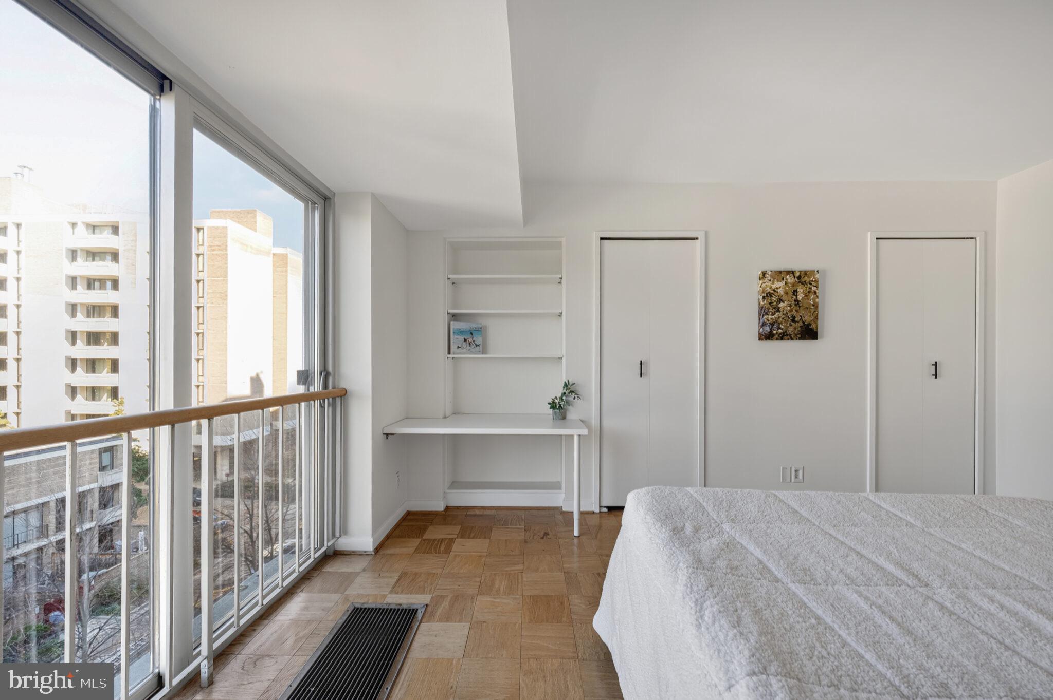 560 N Street Southwest, Unit N503 Washington, DC 20024 - Photo 18 of 35 a bedroom with a bed and a large window