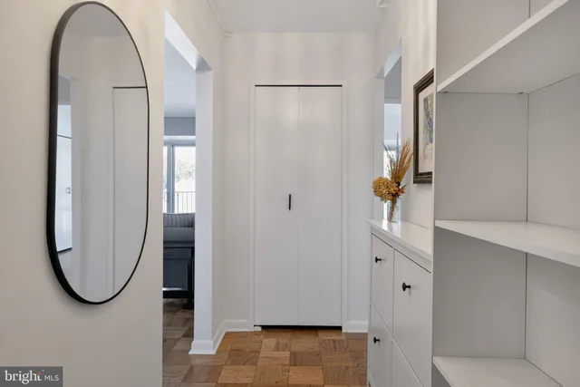 a view of a livingroom with wooden floor and a glass door