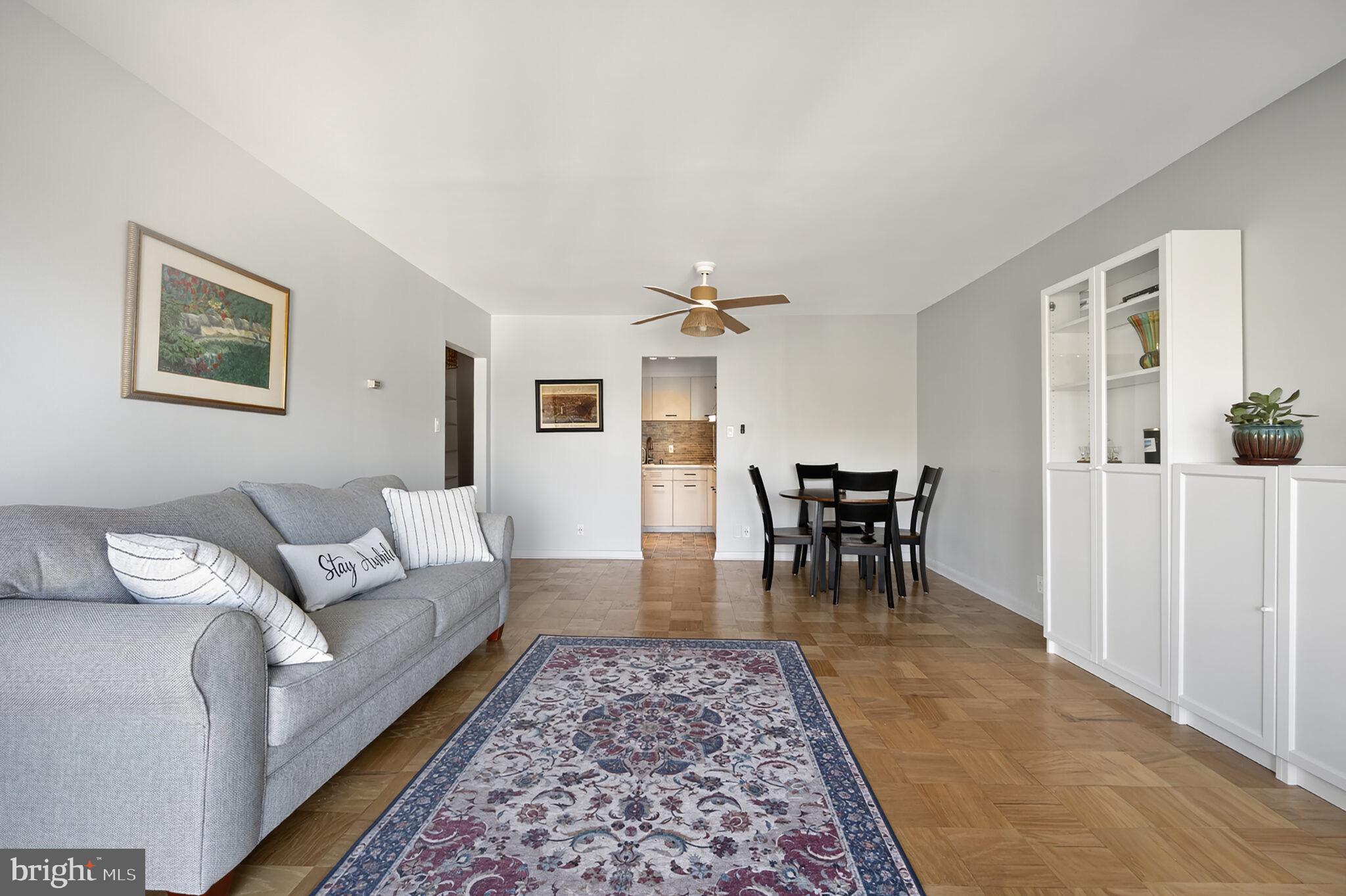 560 N Street Southwest, Unit N503 Washington, DC 20024 - Photo 8 of 35 a living room with furniture and a dining table with rug