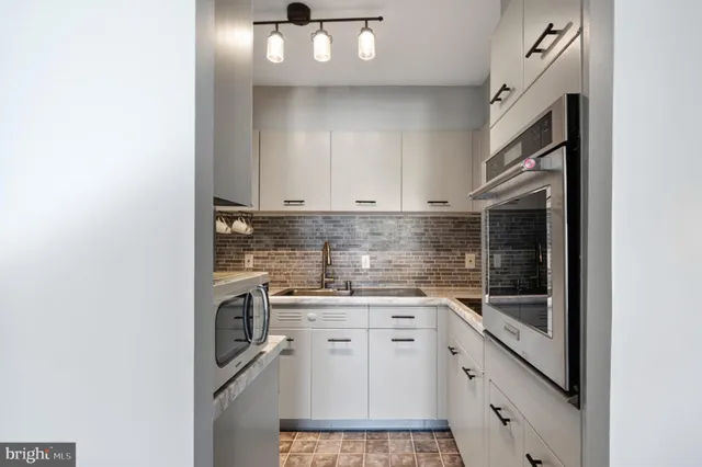 a kitchen with a sink cabinets and appliances