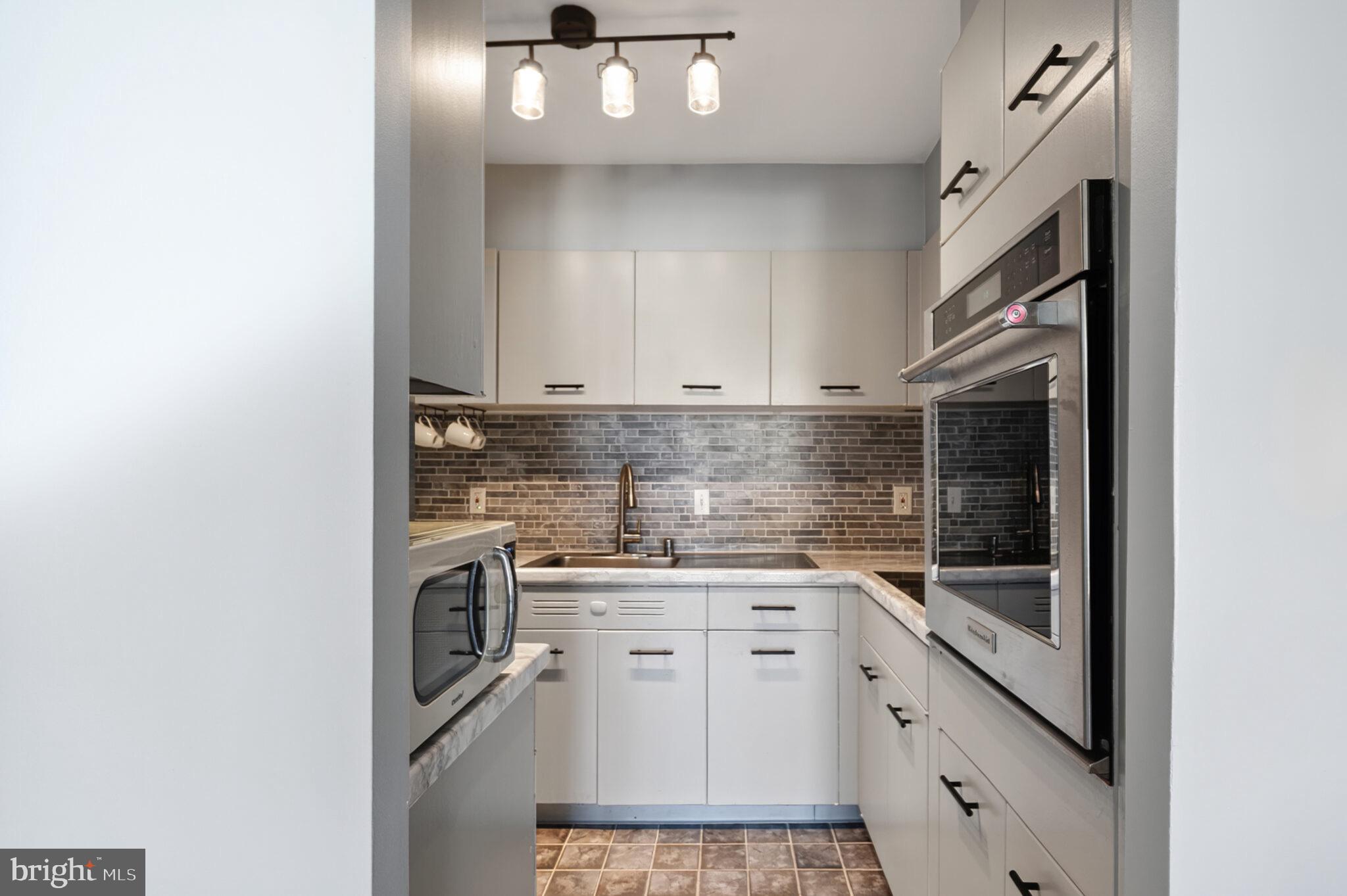 560 N Street Southwest, Unit N503 Washington, DC 20024 - Photo 10 of 35 a kitchen with a sink cabinets and appliances