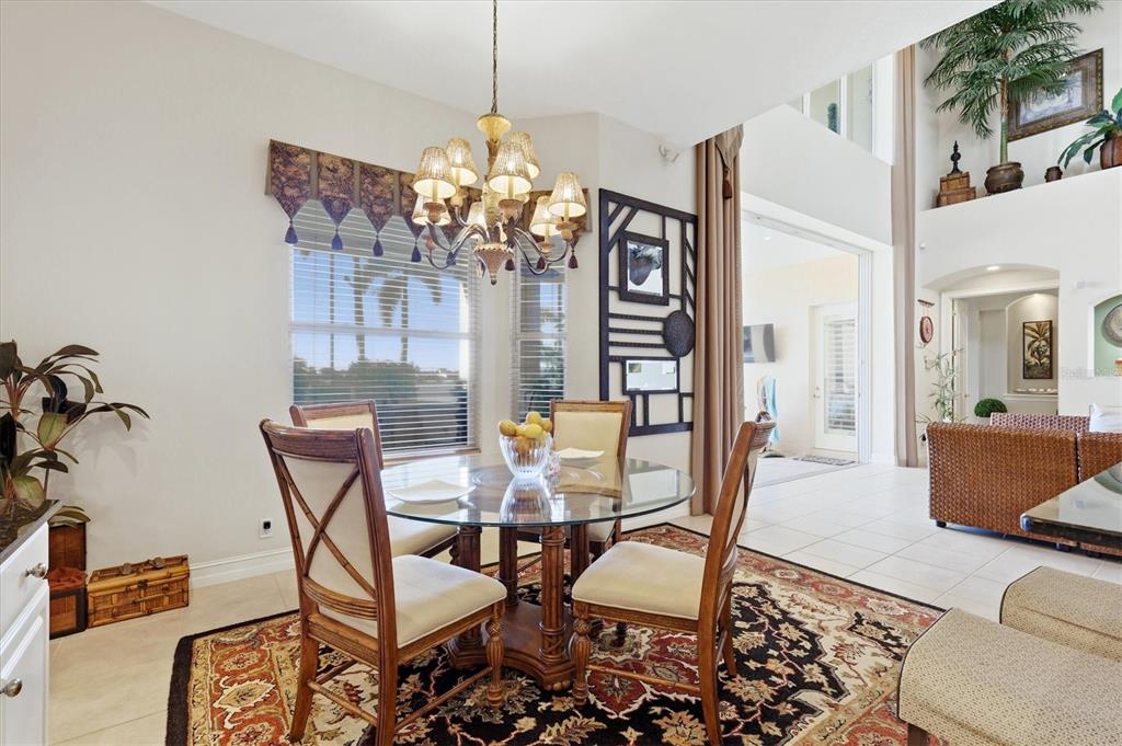 1007 3rd Street East Palmetto, FL 34221 - Photo 13 of 44 a view of a dining room with furniture and chandelier