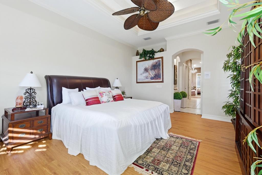 1007 3rd Street East Palmetto, FL 34221 - Photo 17 of 44 a bedroom with a large bed and a chandelier