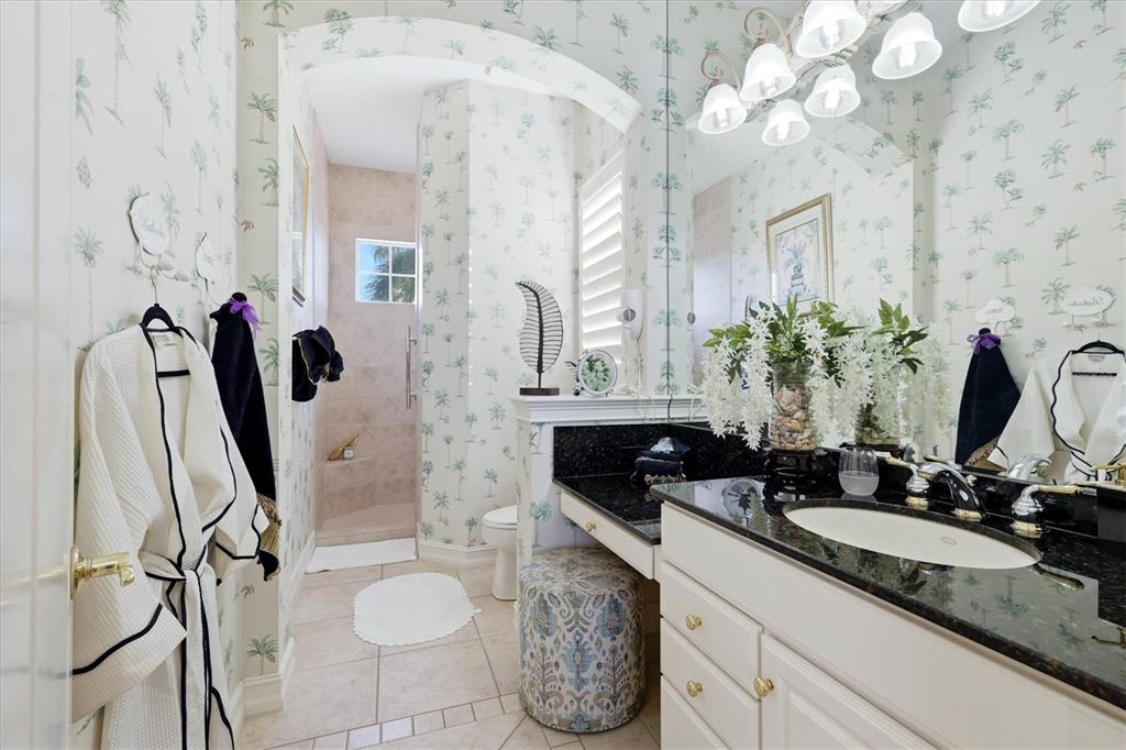 1007 3rd Street East Palmetto, FL 34221 - Photo 22 of 44 a bathroom with a granite countertop sink a mirror and shower