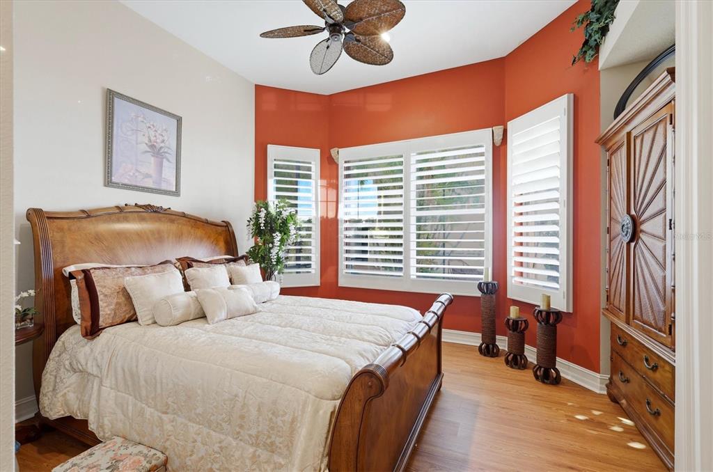 1007 3rd Street East Palmetto, FL 34221 - Photo 25 of 44 a bedroom with a bed and a chandelier
