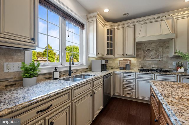a kitchen with lots of counter top space and a potted plant