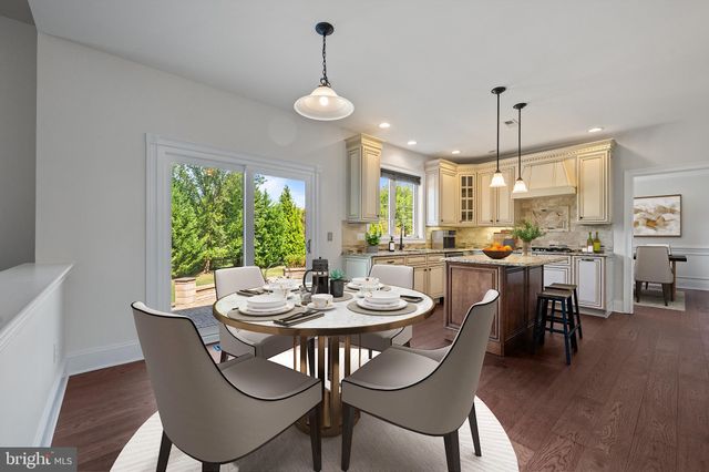 a dining room with furniture a chandelier and wooden floor