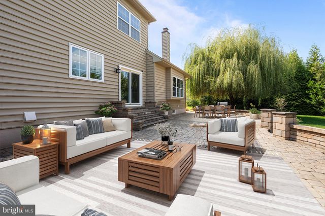 a view of a patio with couches and a fire pit