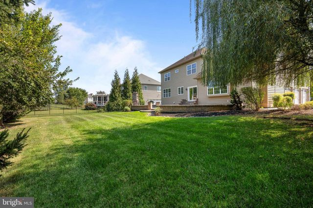 a house view with swimming pool and garden