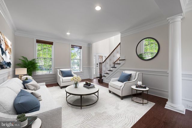 a living room with furniture and a clock