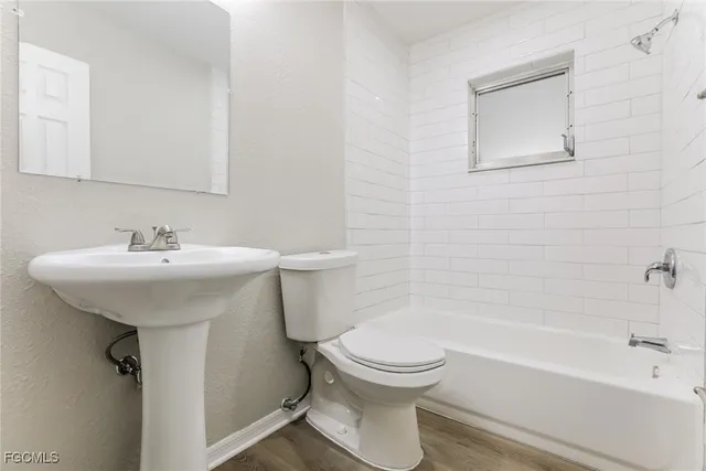 a bathroom with a sink toilet and bathtub