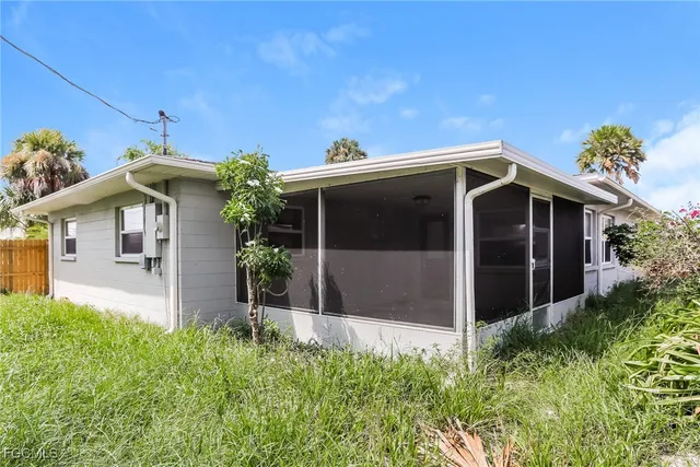 a front view of a house with plants