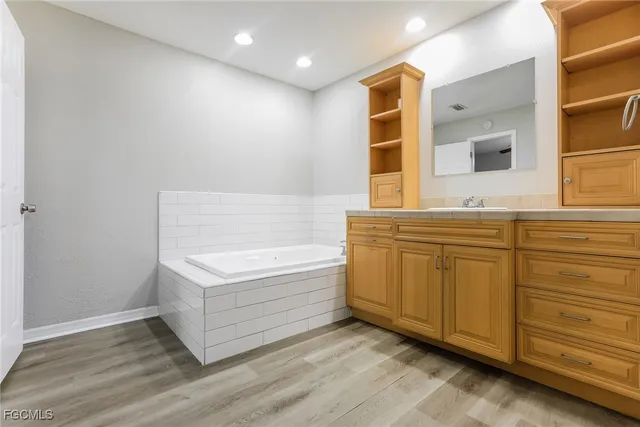 a bathroom with a bathtub and a sink
