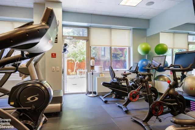 a room with gym equipment and a mirror
