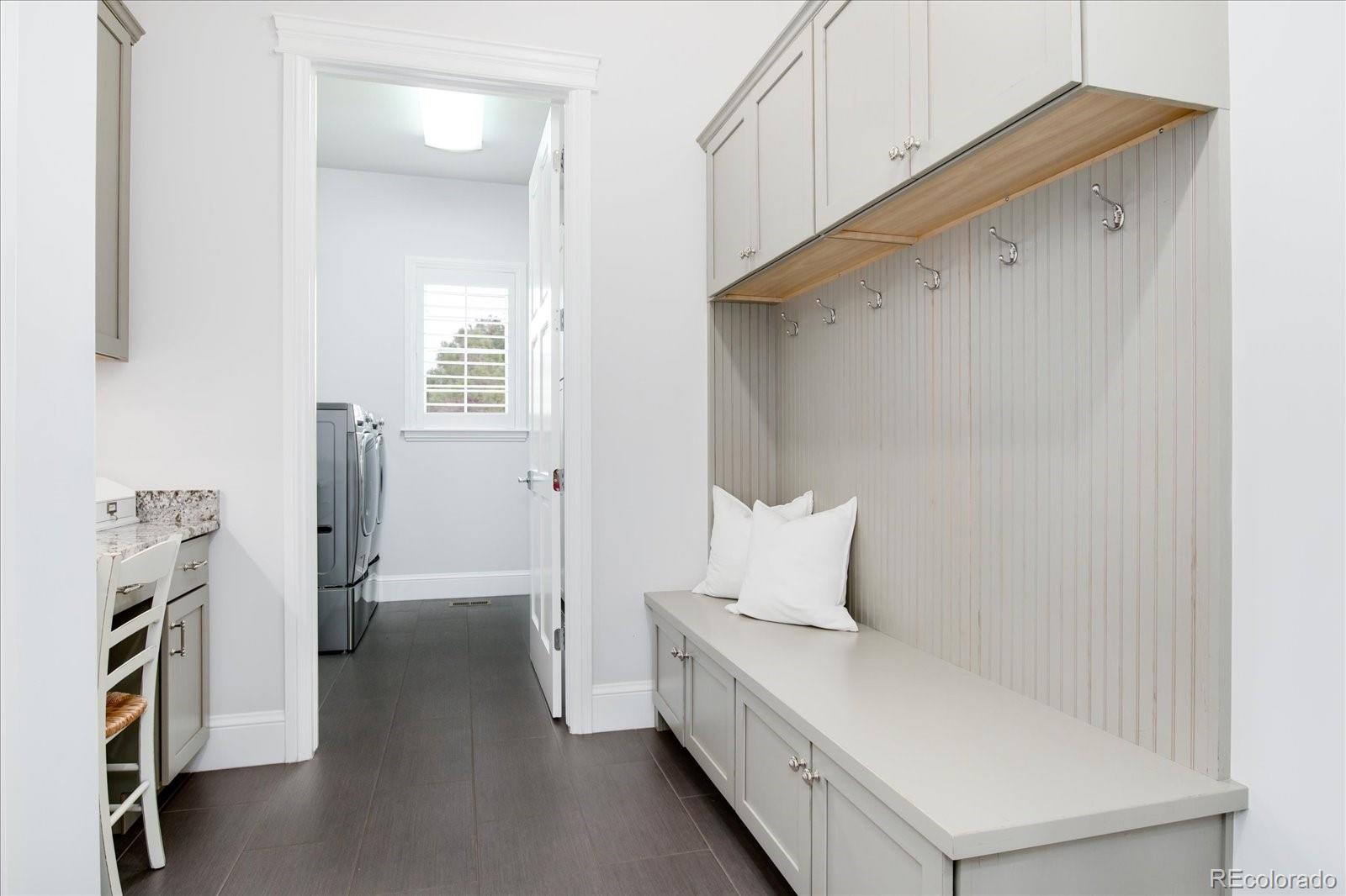 10890 Rainribbon Road Highlands Ranch, CO 80126 - Photo 13 of 40 a hallway with a large window and a refrigerator