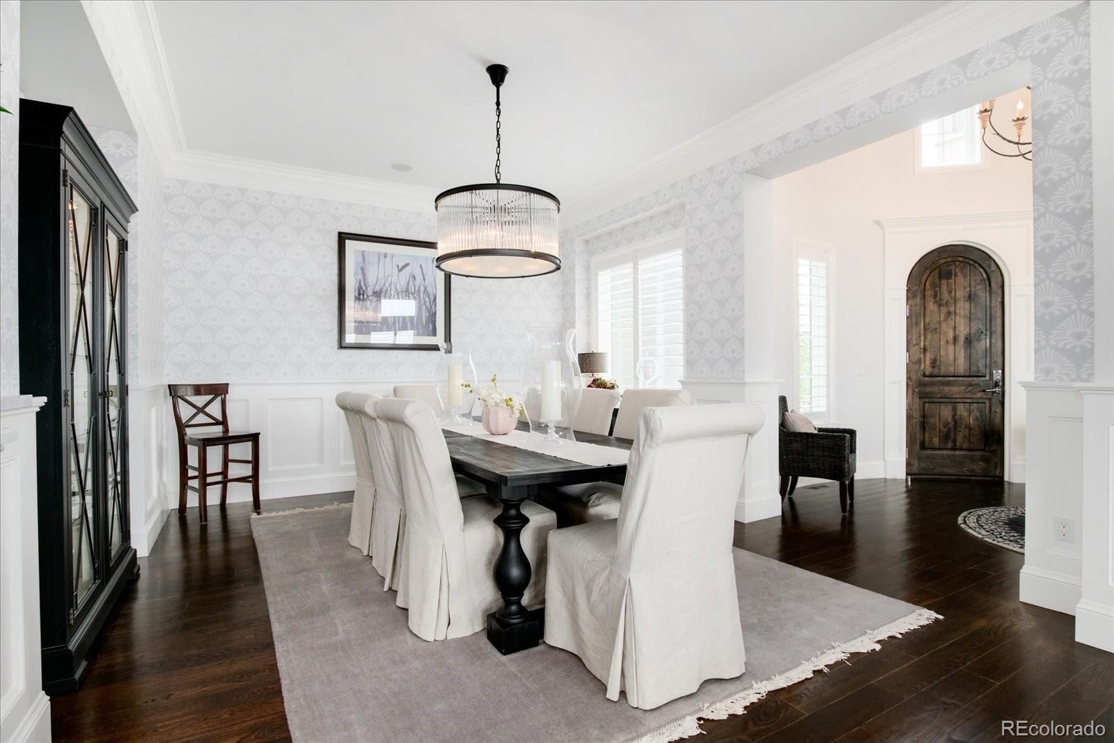 10890 Rainribbon Road Highlands Ranch, CO 80126 - Photo 14 of 40 a view of a dining room with furniture window and wooden floor