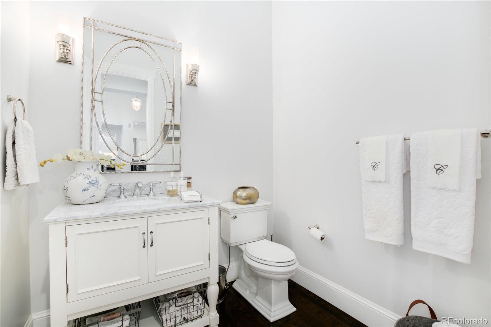 10890 Rainribbon Road Highlands Ranch, CO 80126 - Photo 17 of 40 a bathroom with a granite countertop toilet sink and mirror