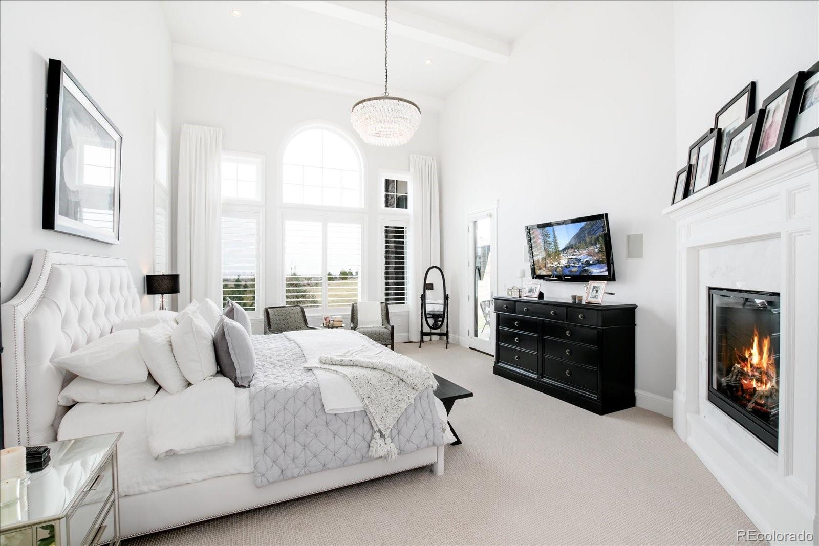 10890 Rainribbon Road Highlands Ranch, CO 80126 - Photo 18 of 40 a bedroom with a bed and a television