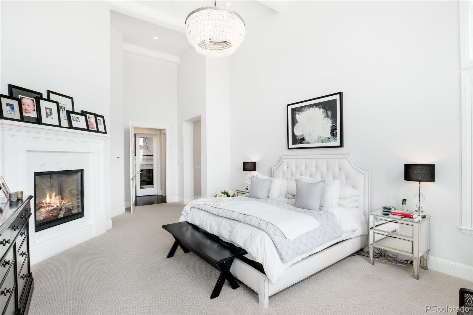 10890 Rainribbon Road Highlands Ranch, CO 80126 - Photo 19 of 40 a bedroom with a bed and a fireplace