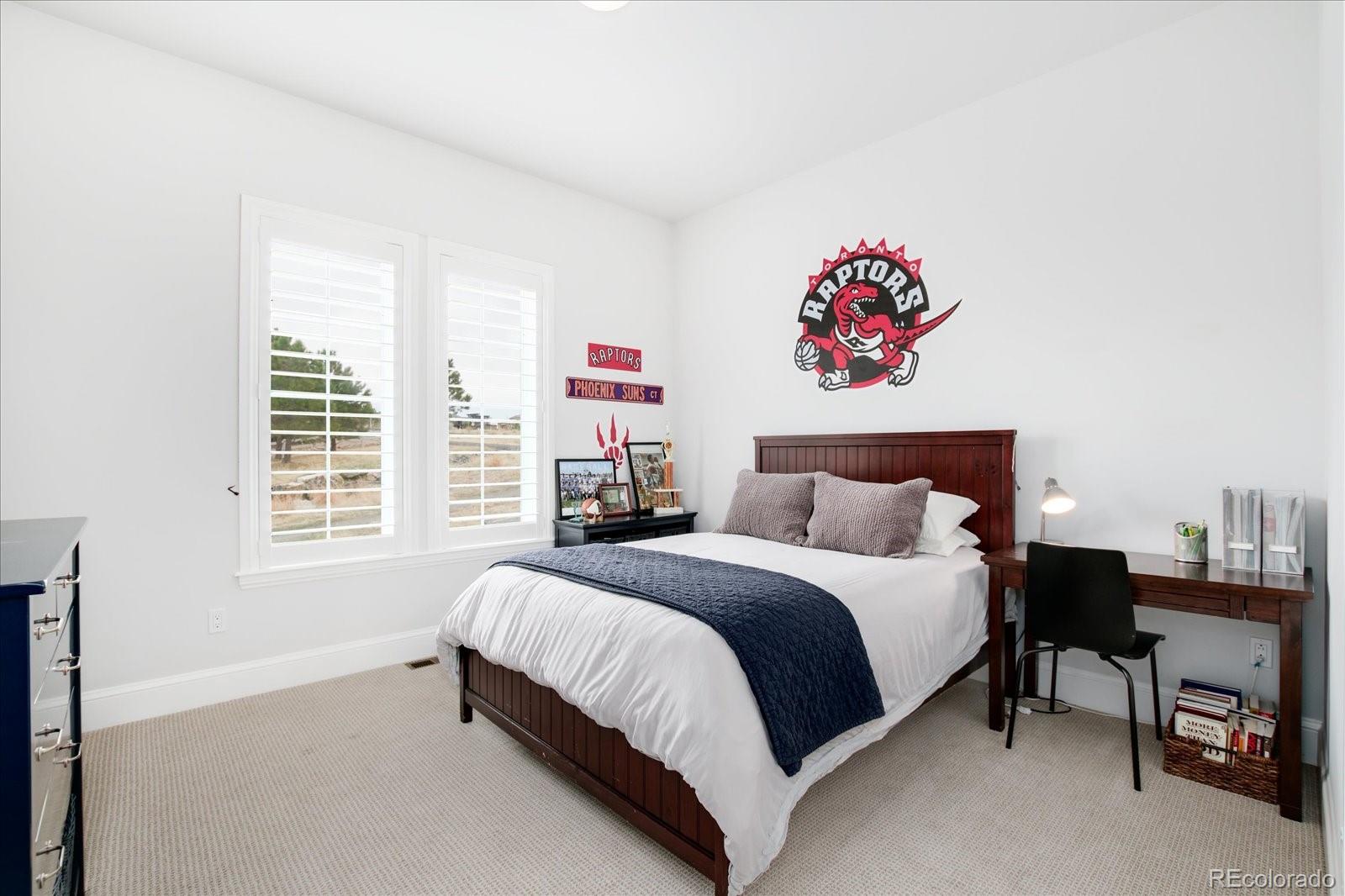 10890 Rainribbon Road Highlands Ranch, CO 80126 - Photo 25 of 40 a spacious bedroom with a bed and a window