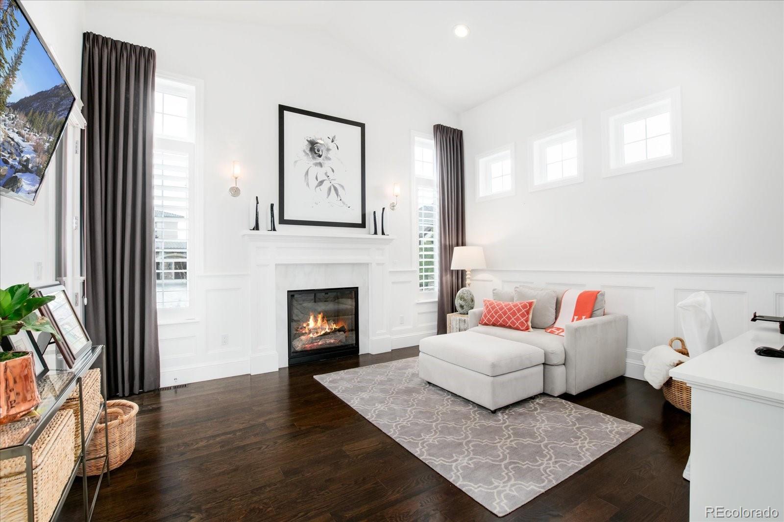 10890 Rainribbon Road Highlands Ranch, CO 80126 - Photo 27 of 40 a living room with furniture and a fireplace