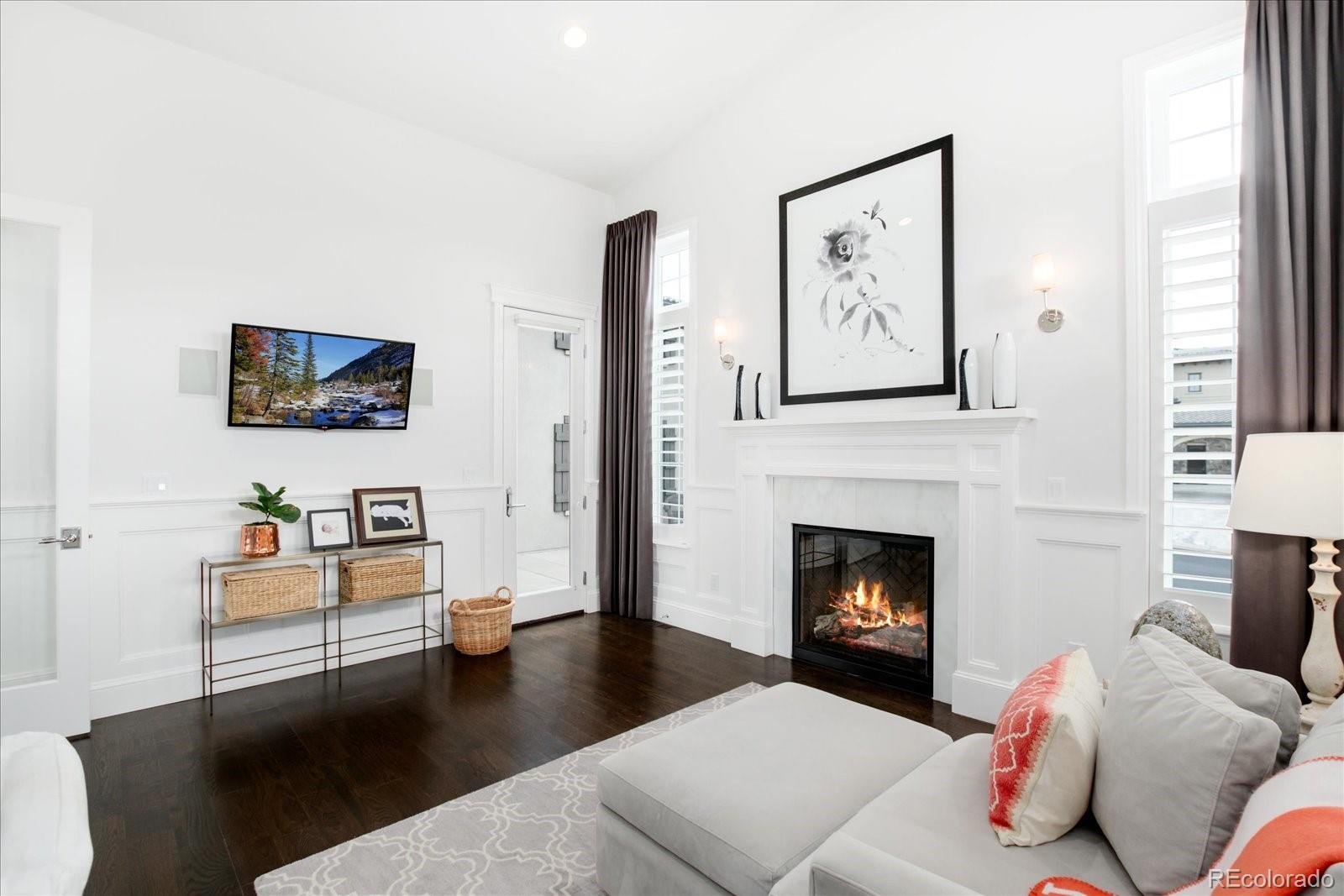 10890 Rainribbon Road Highlands Ranch, CO 80126 - Photo 28 of 40 a living room with furniture and a fireplace