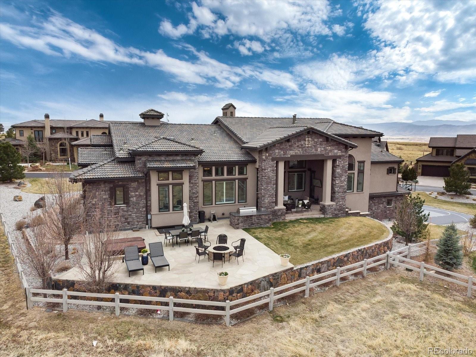 10890 Rainribbon Road Highlands Ranch, CO 80126 - Photo 3 of 40 a view of a house with swimming pool and sitting area