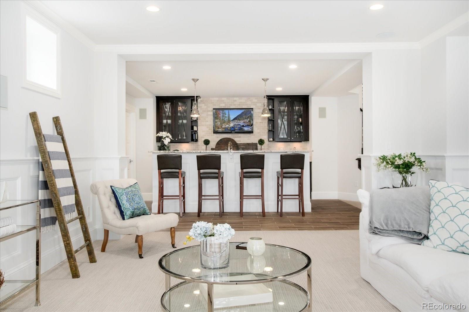 10890 Rainribbon Road Highlands Ranch, CO 80126 - Photo 35 of 40 a living room with furniture a dining table and a fireplace