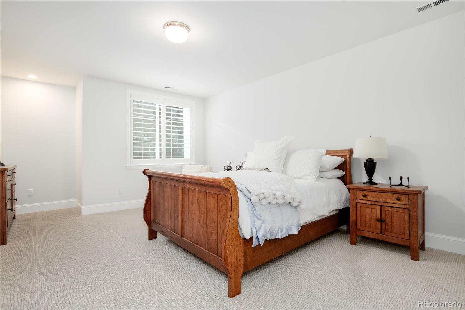 10890 Rainribbon Road Highlands Ranch, CO 80126 - Photo 37 of 40 a bed sitting in a room next to a lamp