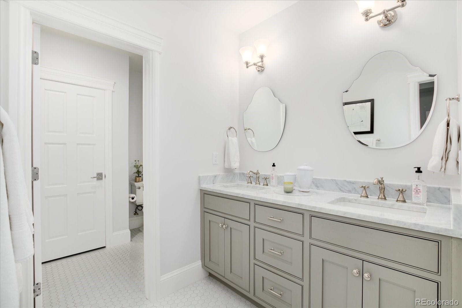 10890 Rainribbon Road Highlands Ranch, CO 80126 - Photo 38 of 40 a bathroom with a double vanity sink and a mirror