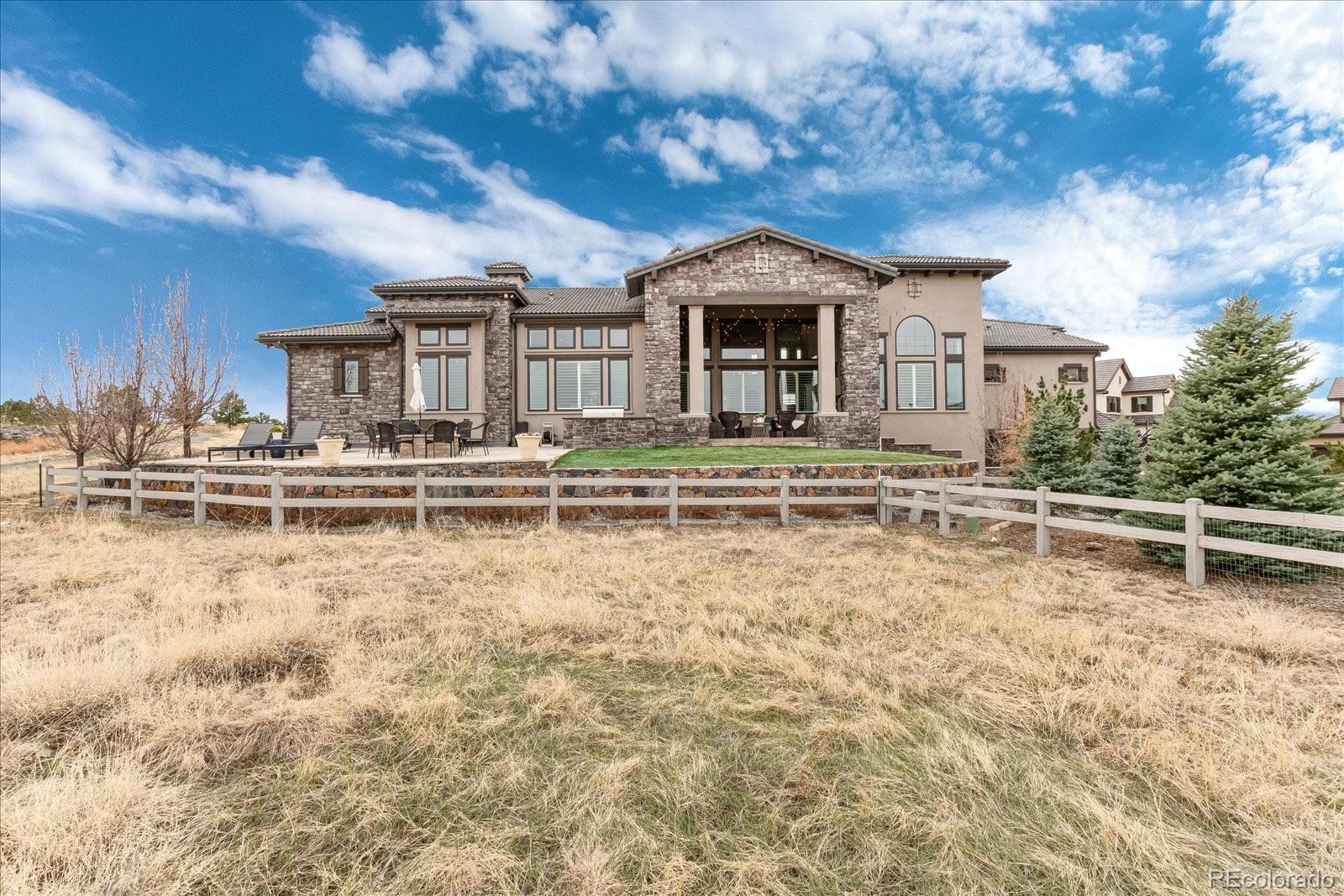 10890 Rainribbon Road Highlands Ranch, CO 80126 - Photo 40 of 40 a front view of a house with swimming pool