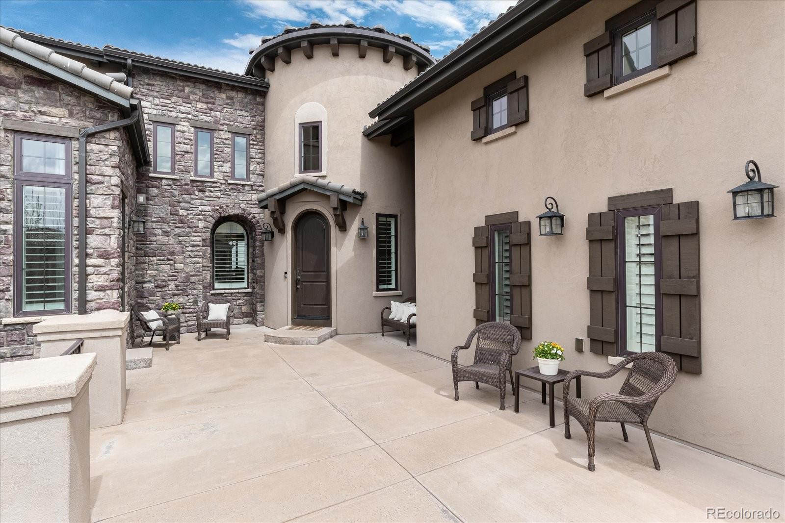 10890 Rainribbon Road Highlands Ranch, CO 80126 - Photo 4 of 40 a view of a patio with couches table and chairs and potted plants