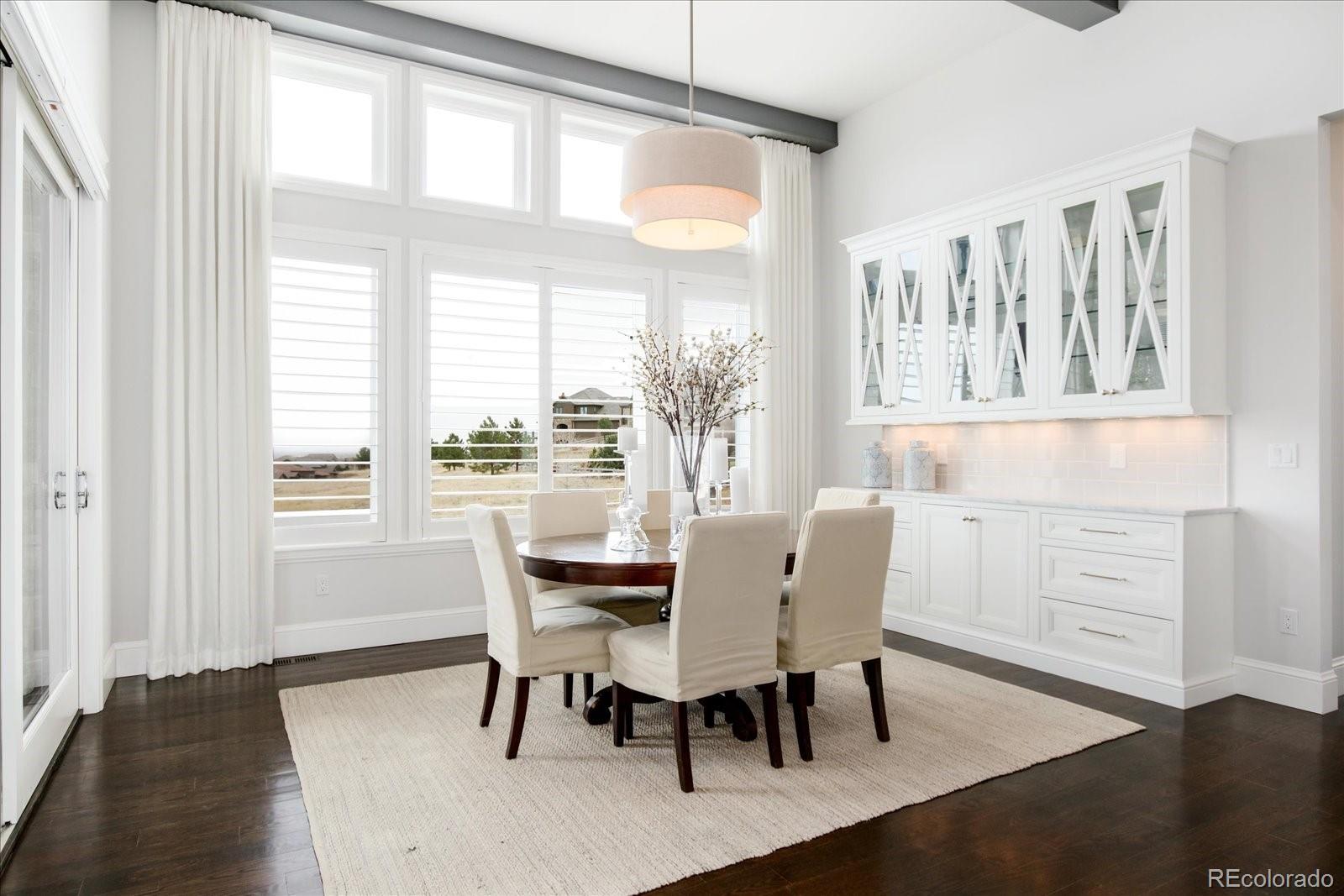 10890 Rainribbon Road Highlands Ranch, CO 80126 - Photo 10 of 40 a dining room with furniture window wooden floor