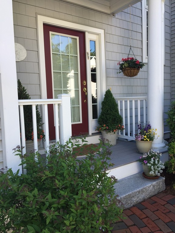a house with potted plants in front of door