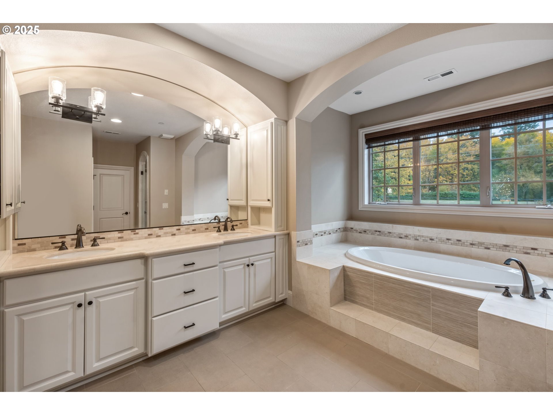 4530 Southwest Council Crest Drive Portland, OR 97239 - Photo 22 of 43 a bathroom with a tub a sink and a large mirror