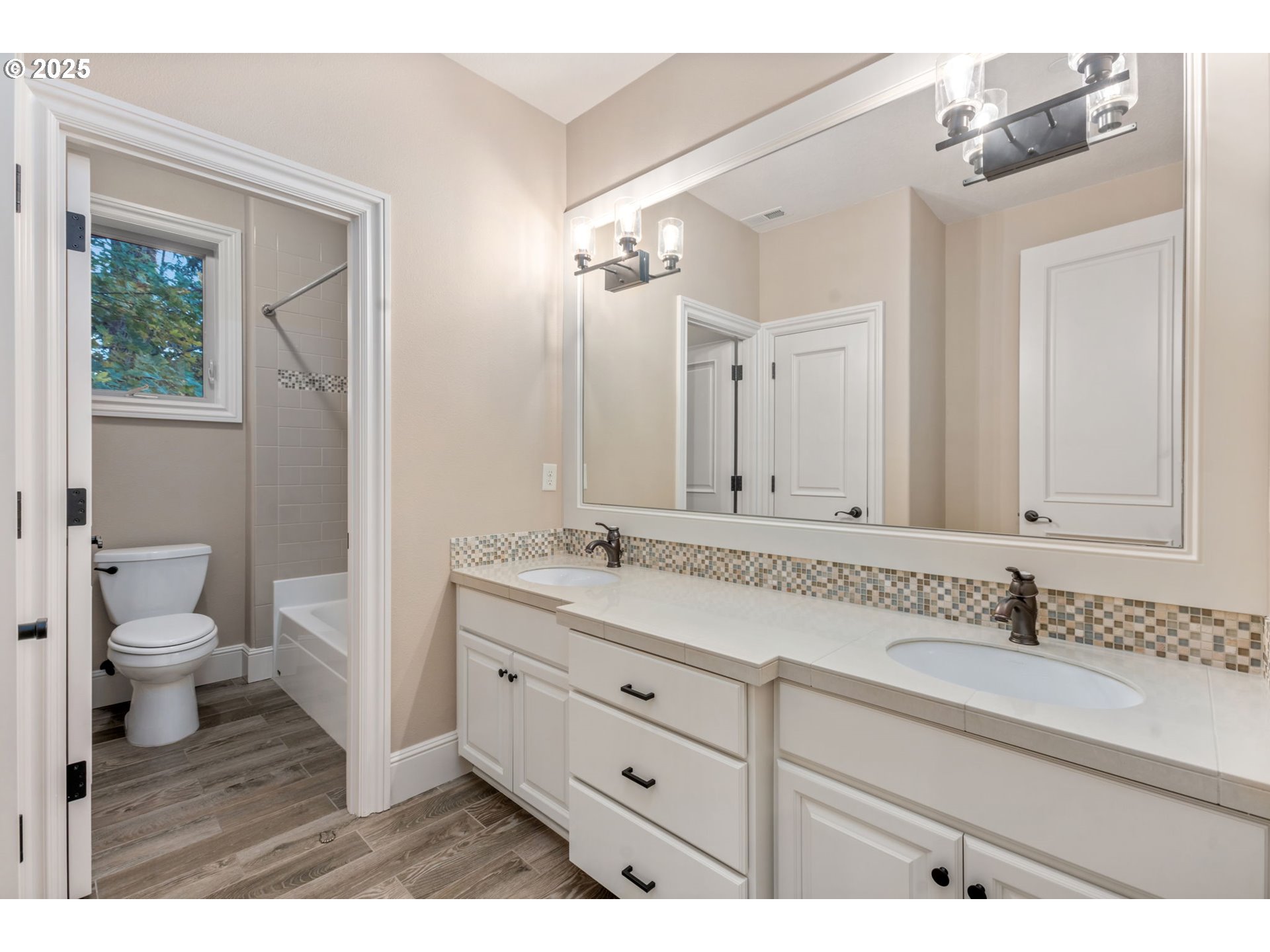 4530 Southwest Council Crest Drive Portland, OR 97239 - Photo 27 of 43 a bathroom with a granite countertop sink a toilet and a mirror
