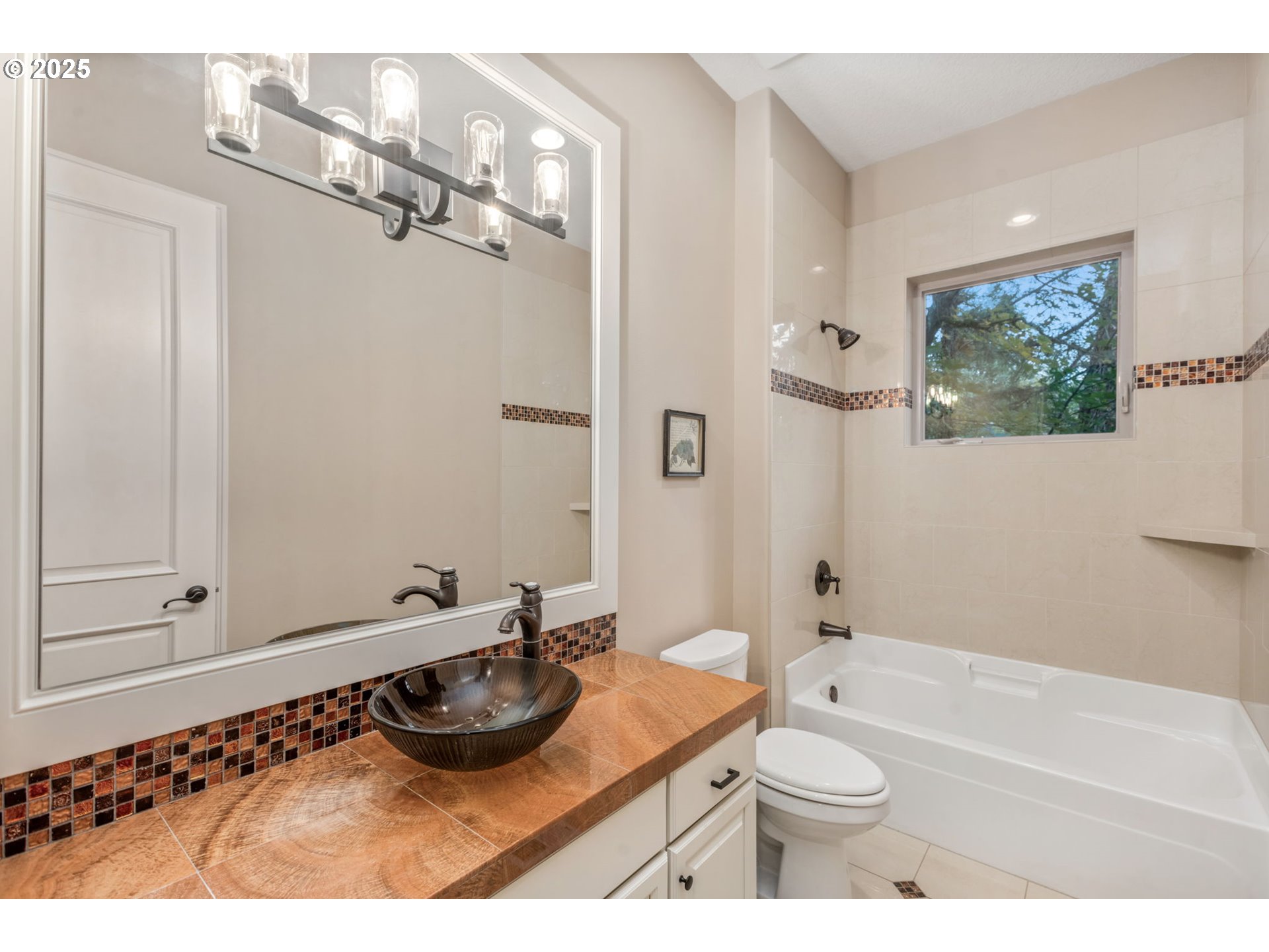 4530 Southwest Council Crest Drive Portland, OR 97239 - Photo 30 of 43 a bathroom with a granite countertop sink a toilet a mirror and shower