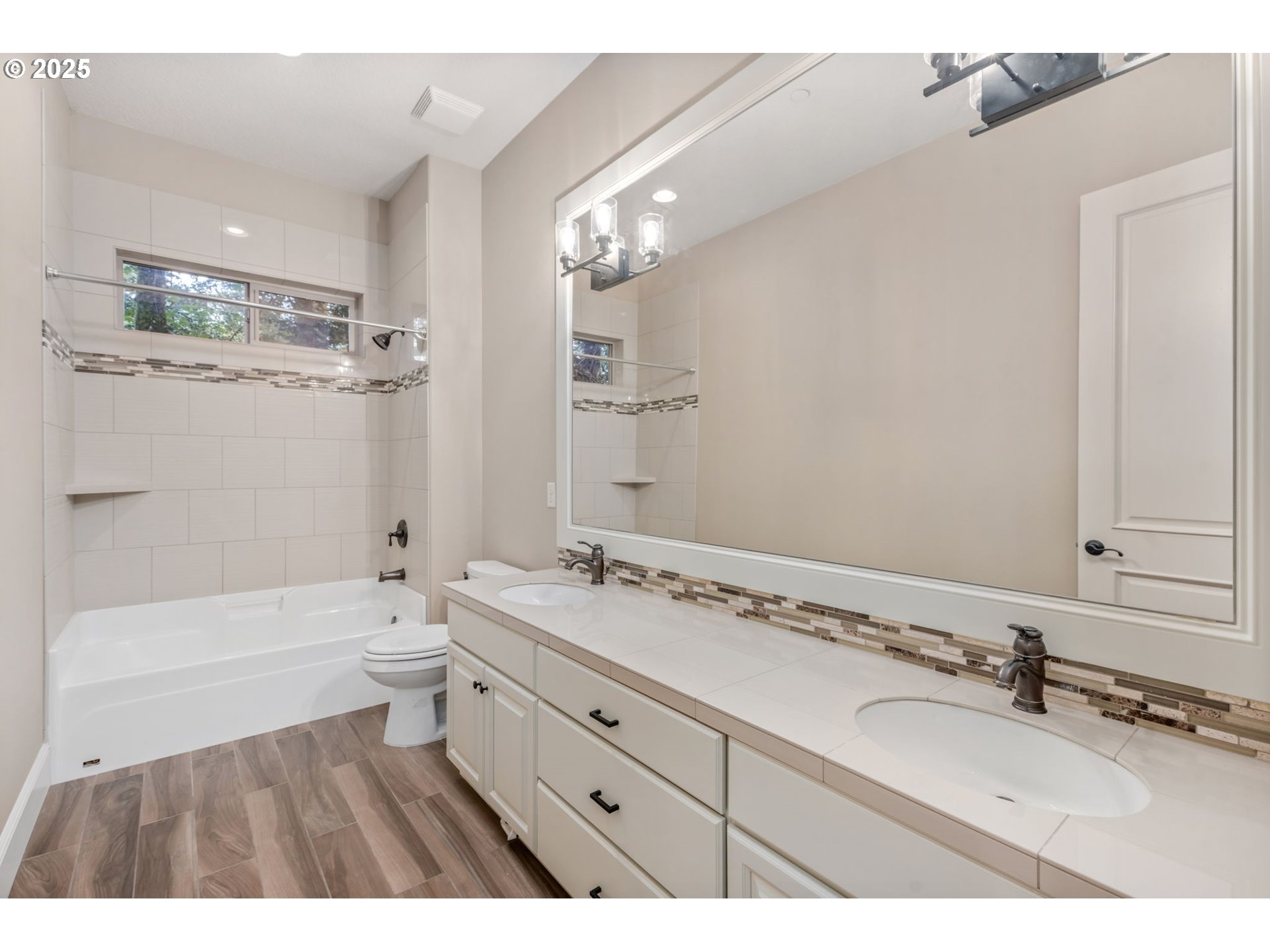 4530 Southwest Council Crest Drive Portland, OR 97239 - Photo 39 of 43 a bathroom with a sink double vanity granite tub toilet and a mirror