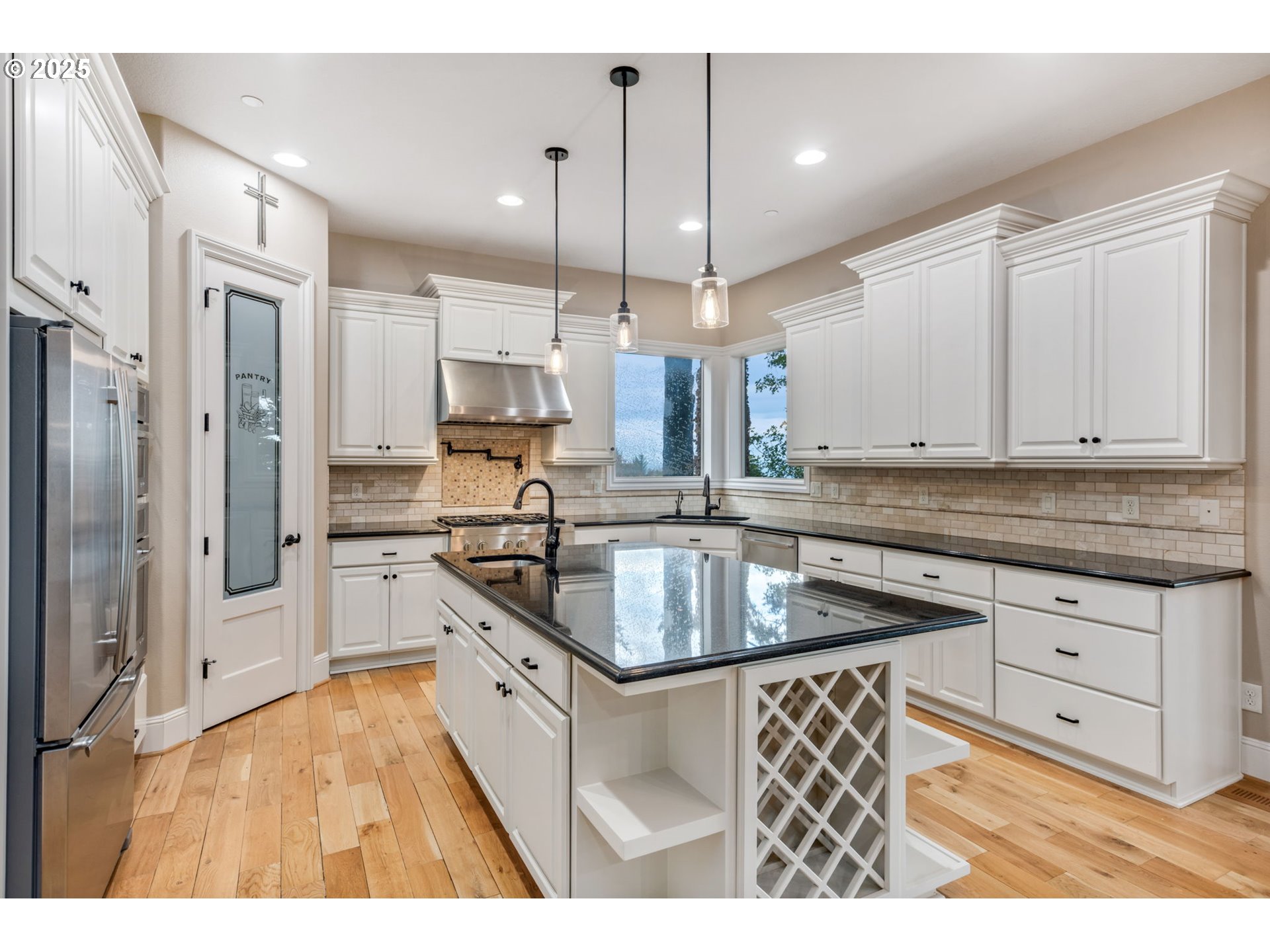 4530 Southwest Council Crest Drive Portland, OR 97239 - Photo 7 of 43 a kitchen with stainless steel appliances granite countertop a sink a stove and a refrigerator