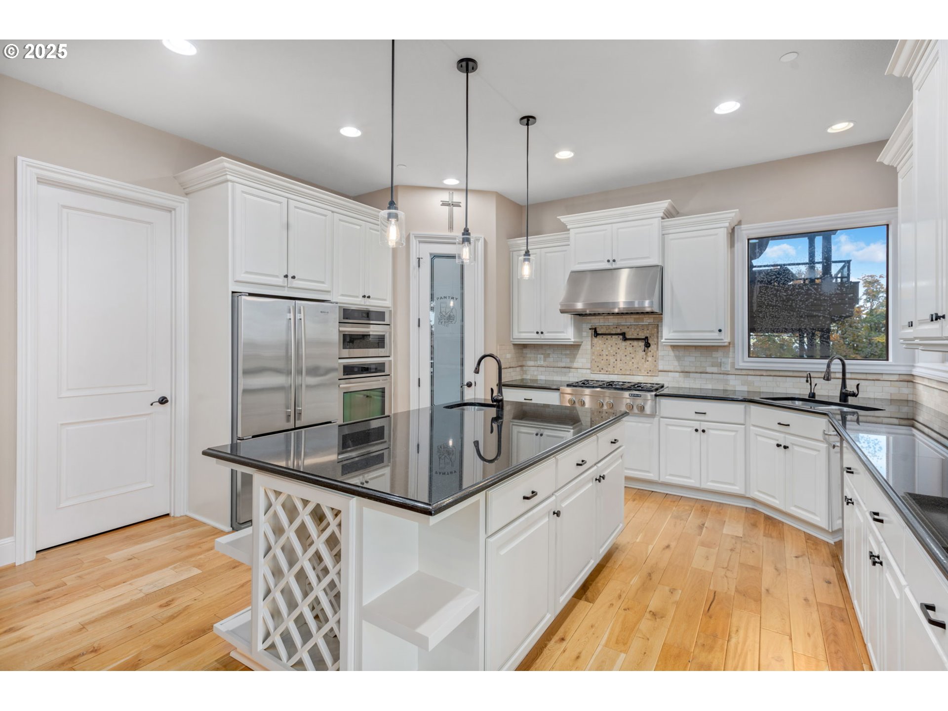 4530 Southwest Council Crest Drive Portland, OR 97239 - Photo 8 of 43 a kitchen with kitchen island a counter top space appliances and cabinets